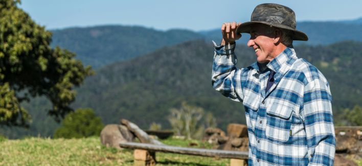 Man Wearing Blue and White Checked Sport Shirt and Black Hat